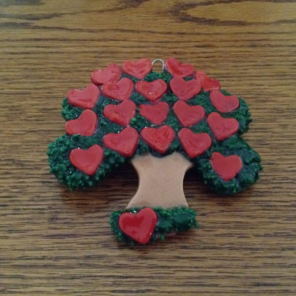 A tree with hearts on it is sitting on the table.