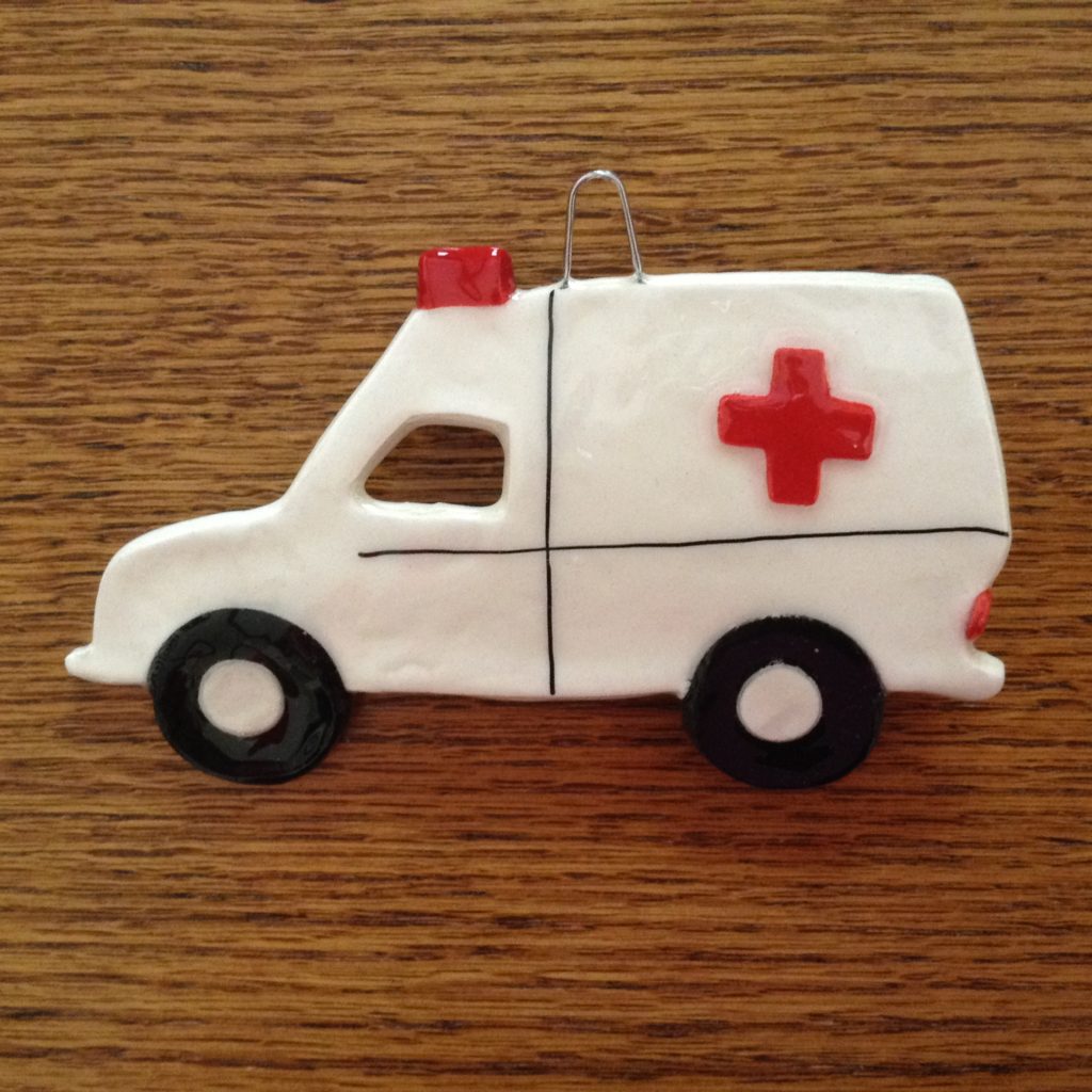 A white ambulance with red cross on it.