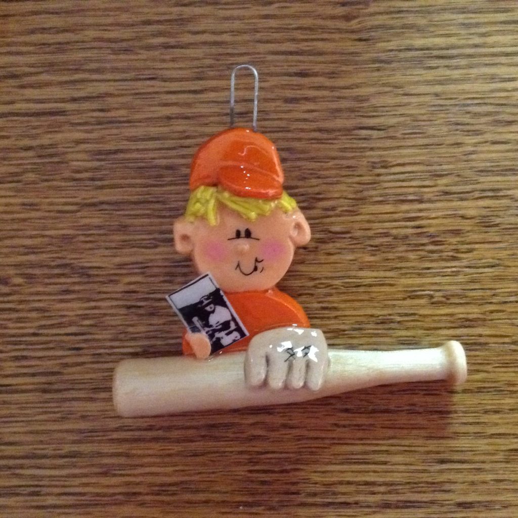 A baseball player ornament with bat and ball.