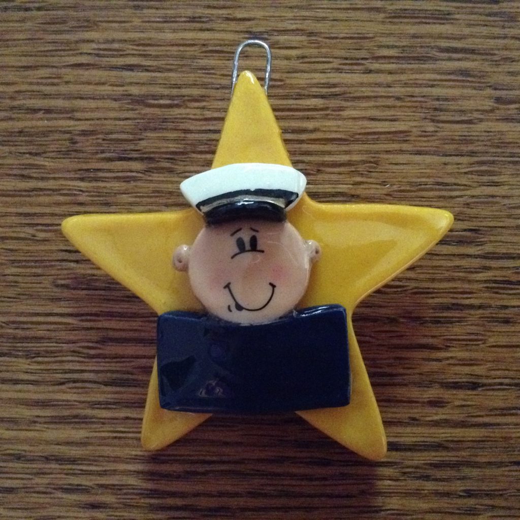 A yellow star with a sailor 's face on it.