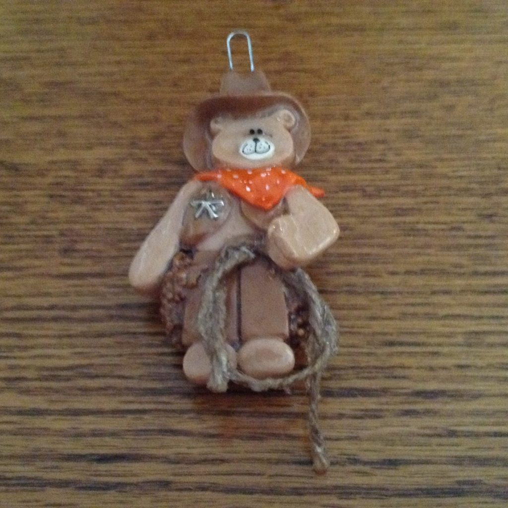 A brown teddy bear with a bow and arrow.