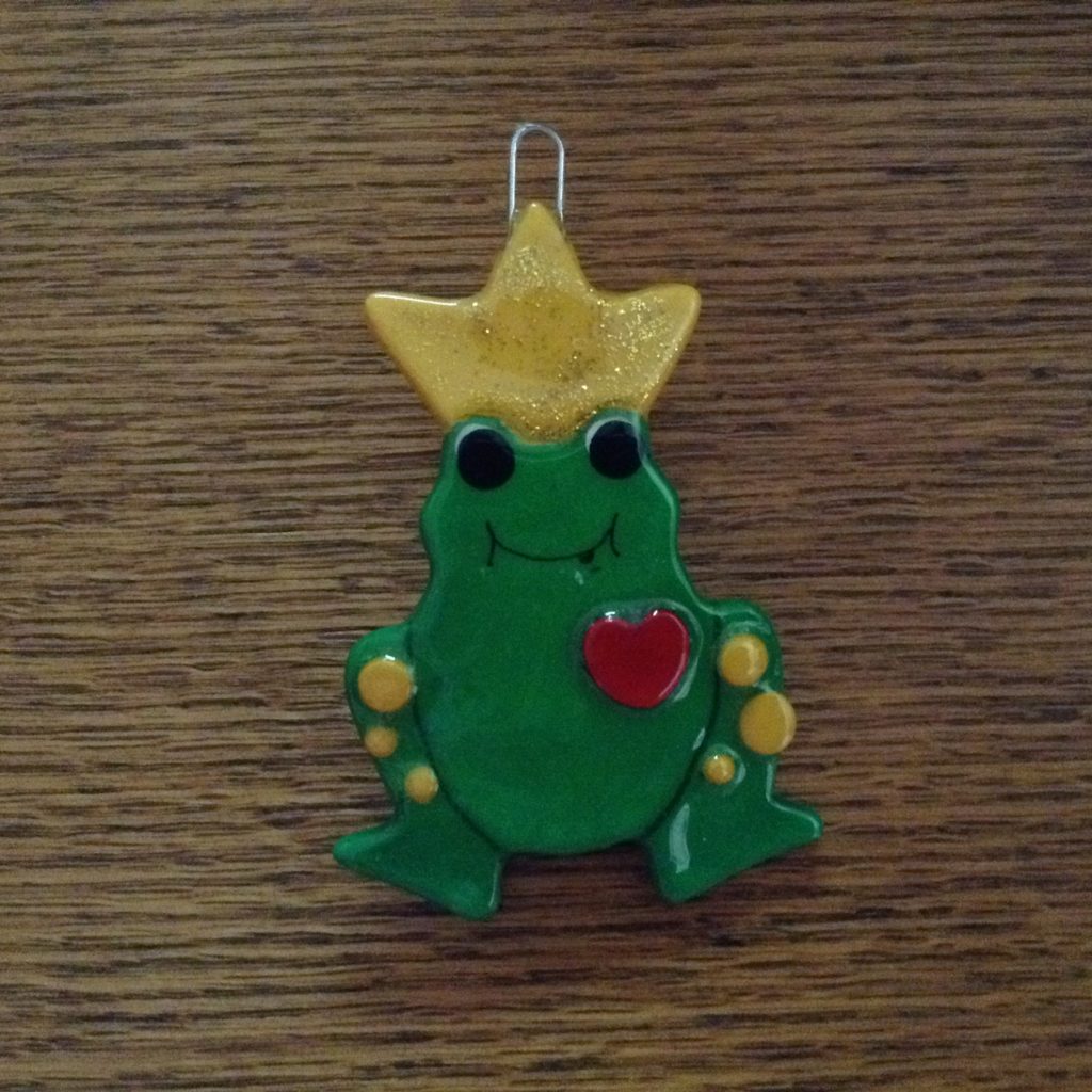 A green frog with a yellow crown on it's head.
