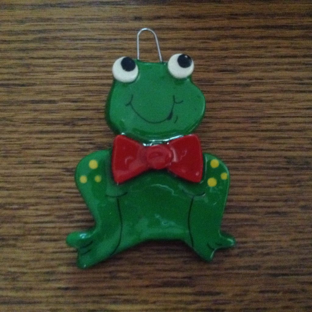 A green frog with a red bow tie.
