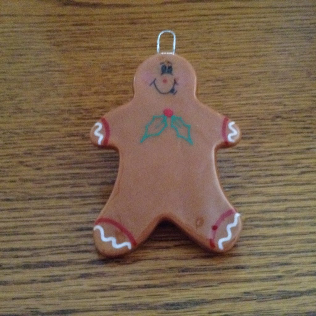 A gingerbread man ornament is sitting on the table.