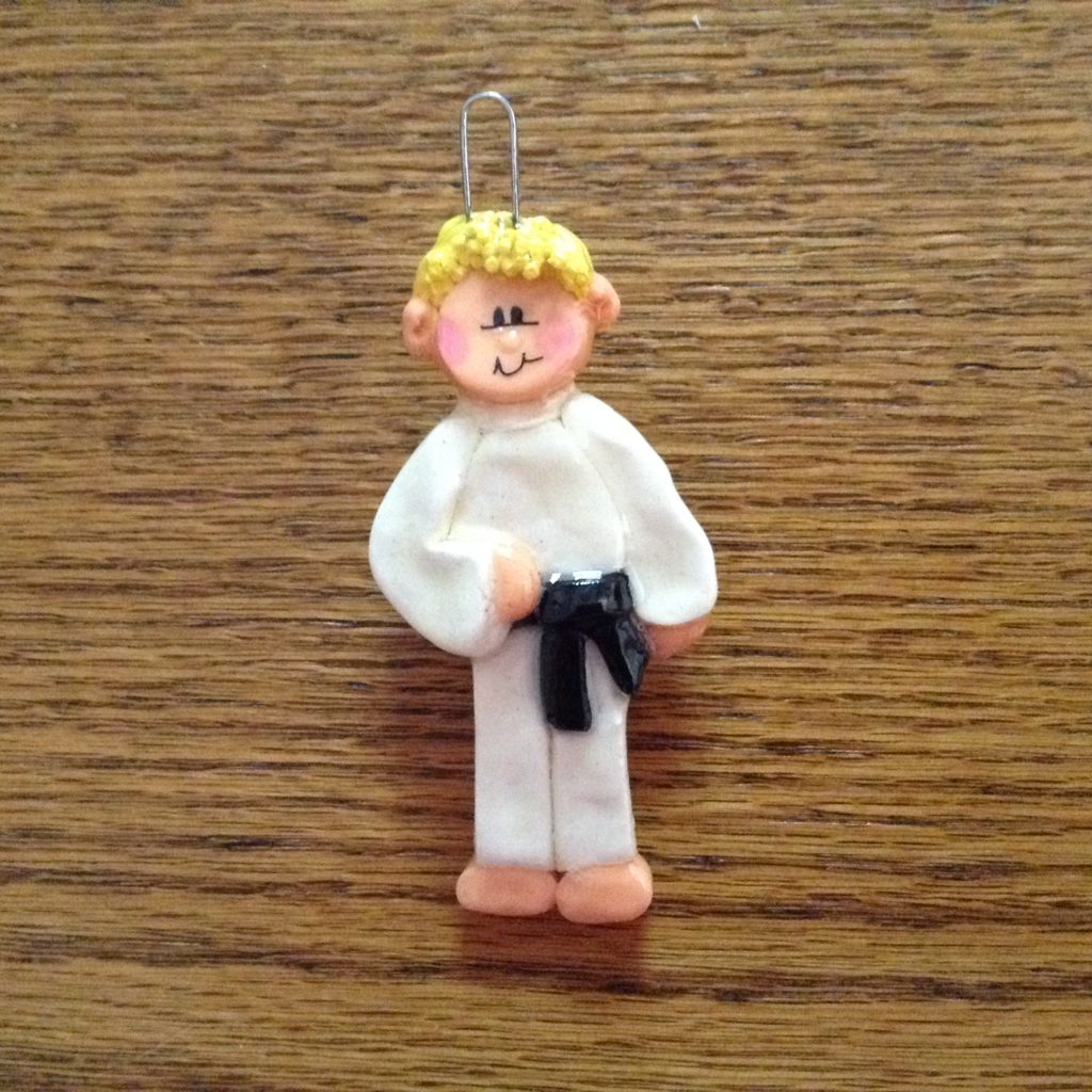 A small figurine of a man in white clothes.