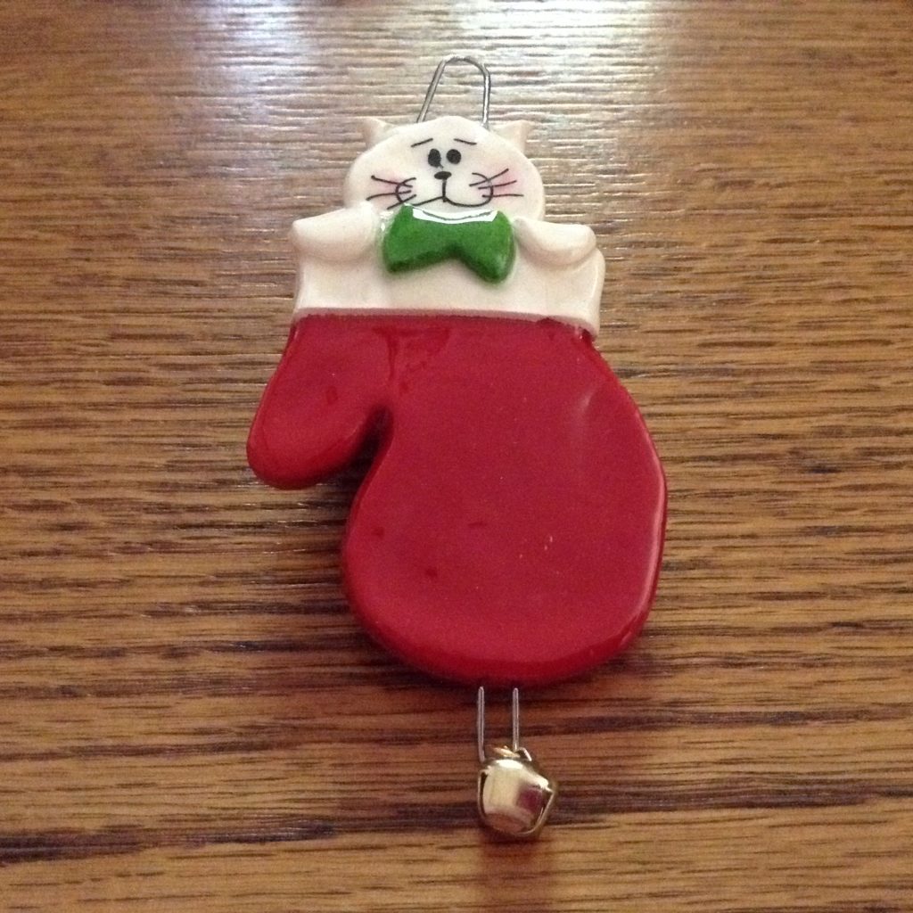 A cat ornament is hanging on the table.