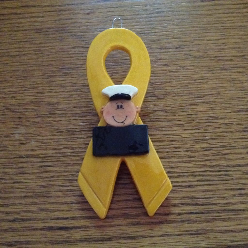 A yellow ribbon with a sailor on it.