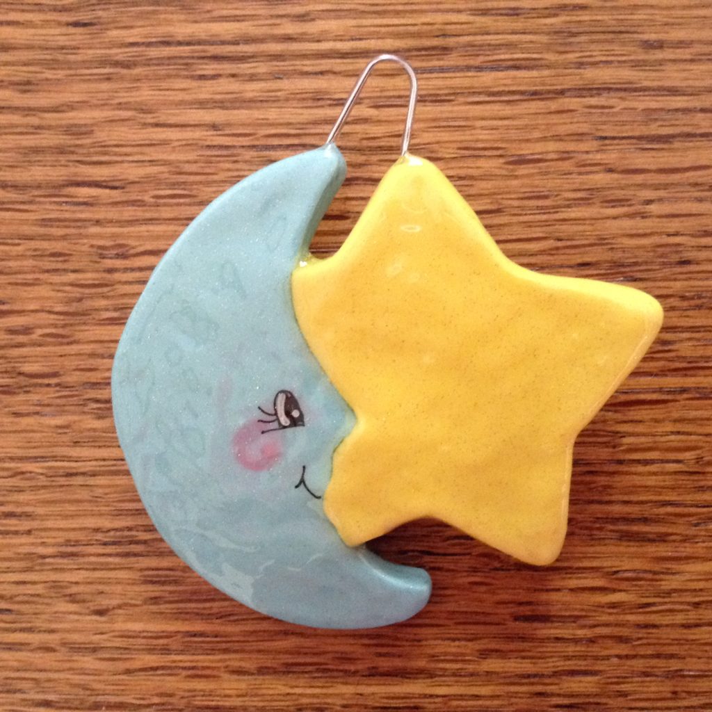A star and moon ornament on the table.