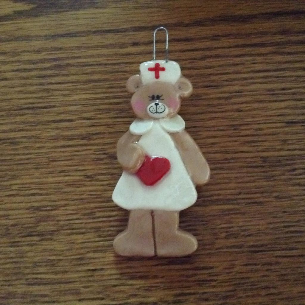 A nurse bear ornament is on the table.