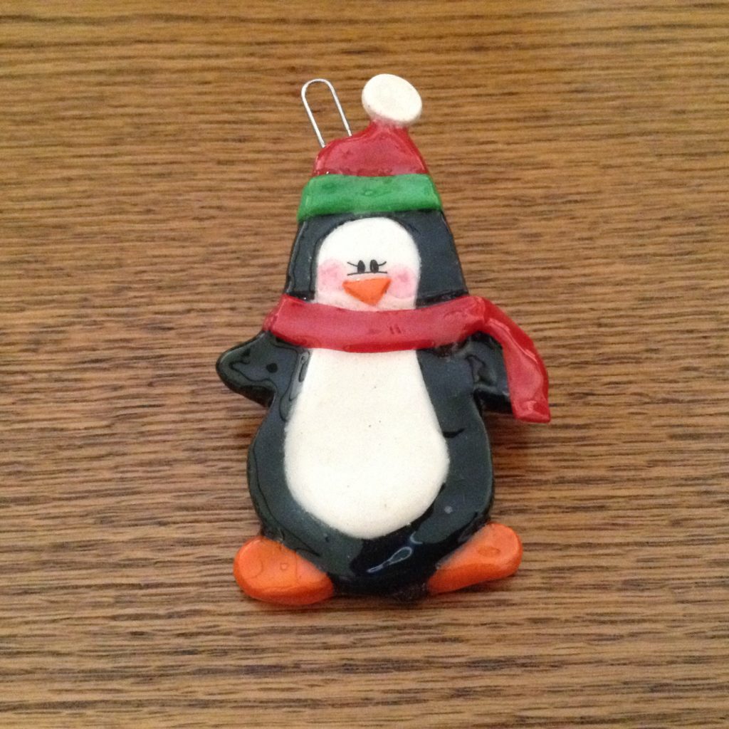 A penguin ornament is sitting on the table.