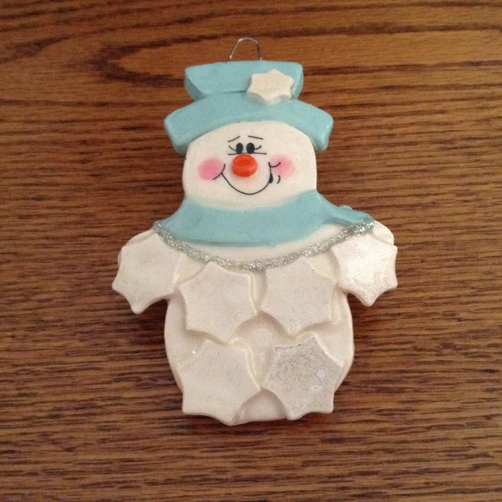 A snowman cookie is sitting on top of the table.