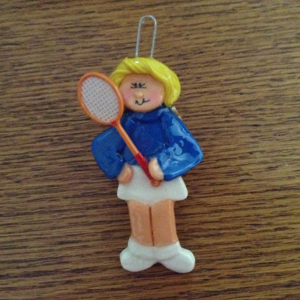 A tennis player ornament is on the table.