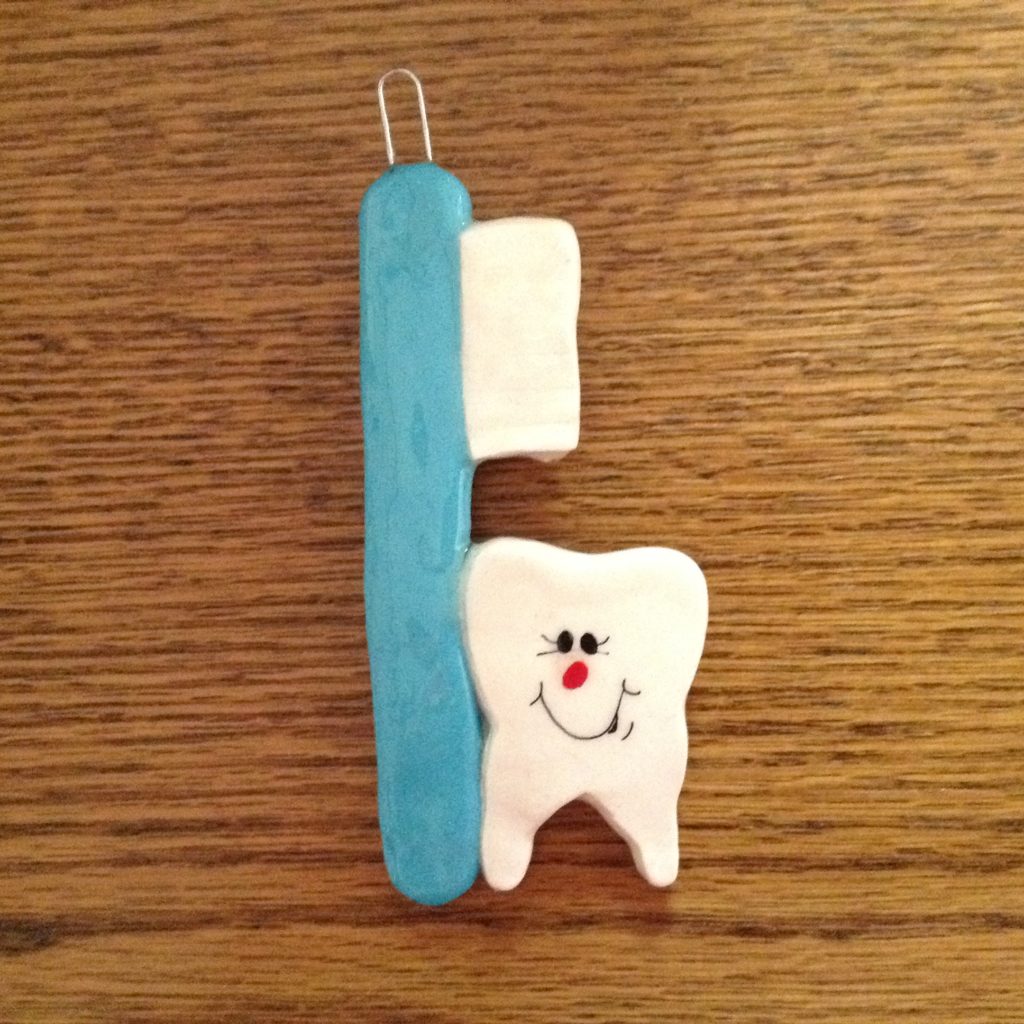 A tooth and toothbrush on the table
