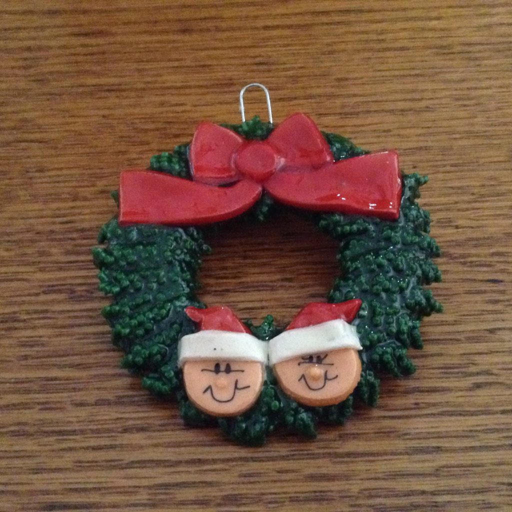 A christmas ornament with two faces in the middle of it.