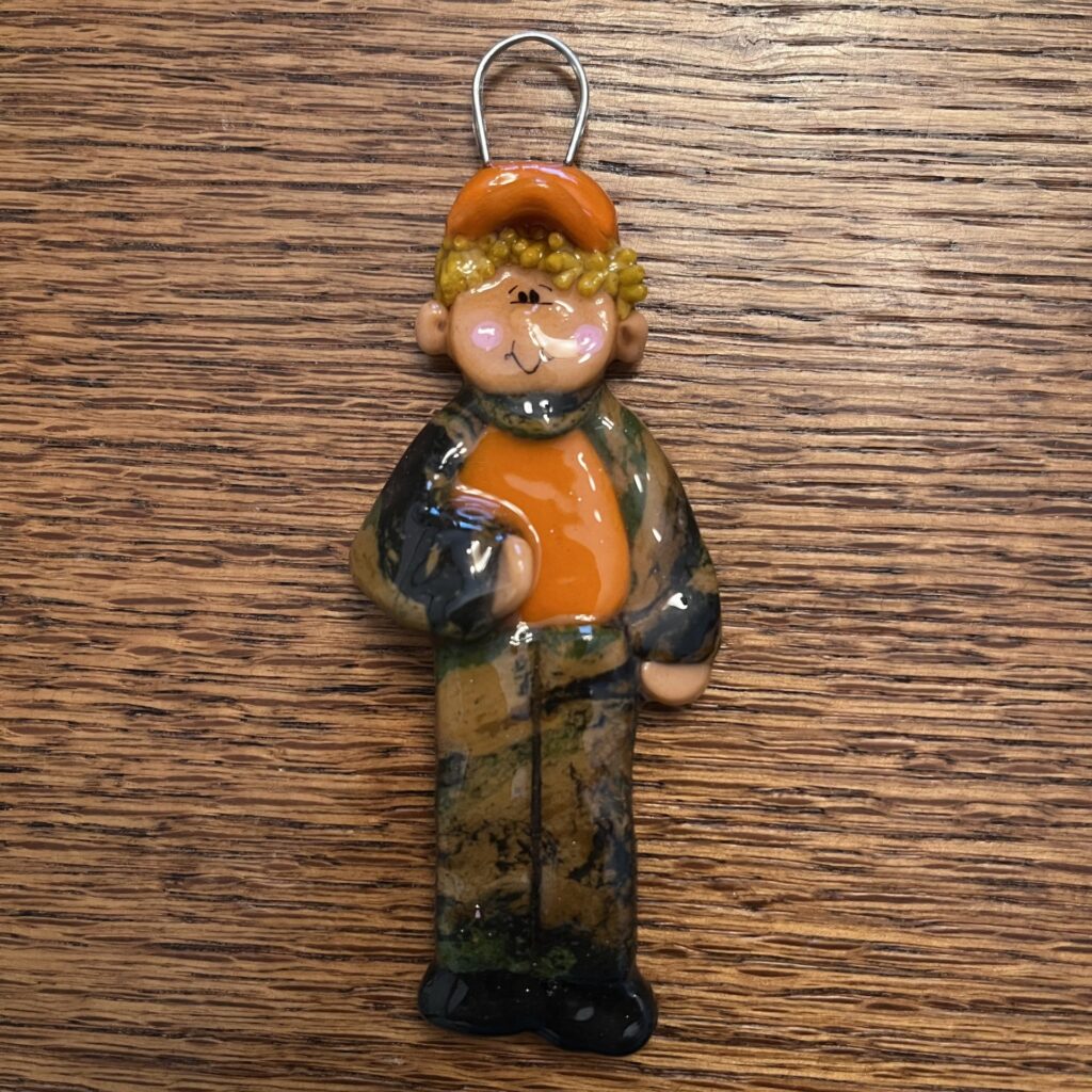 A small figurine of a man holding a ball.