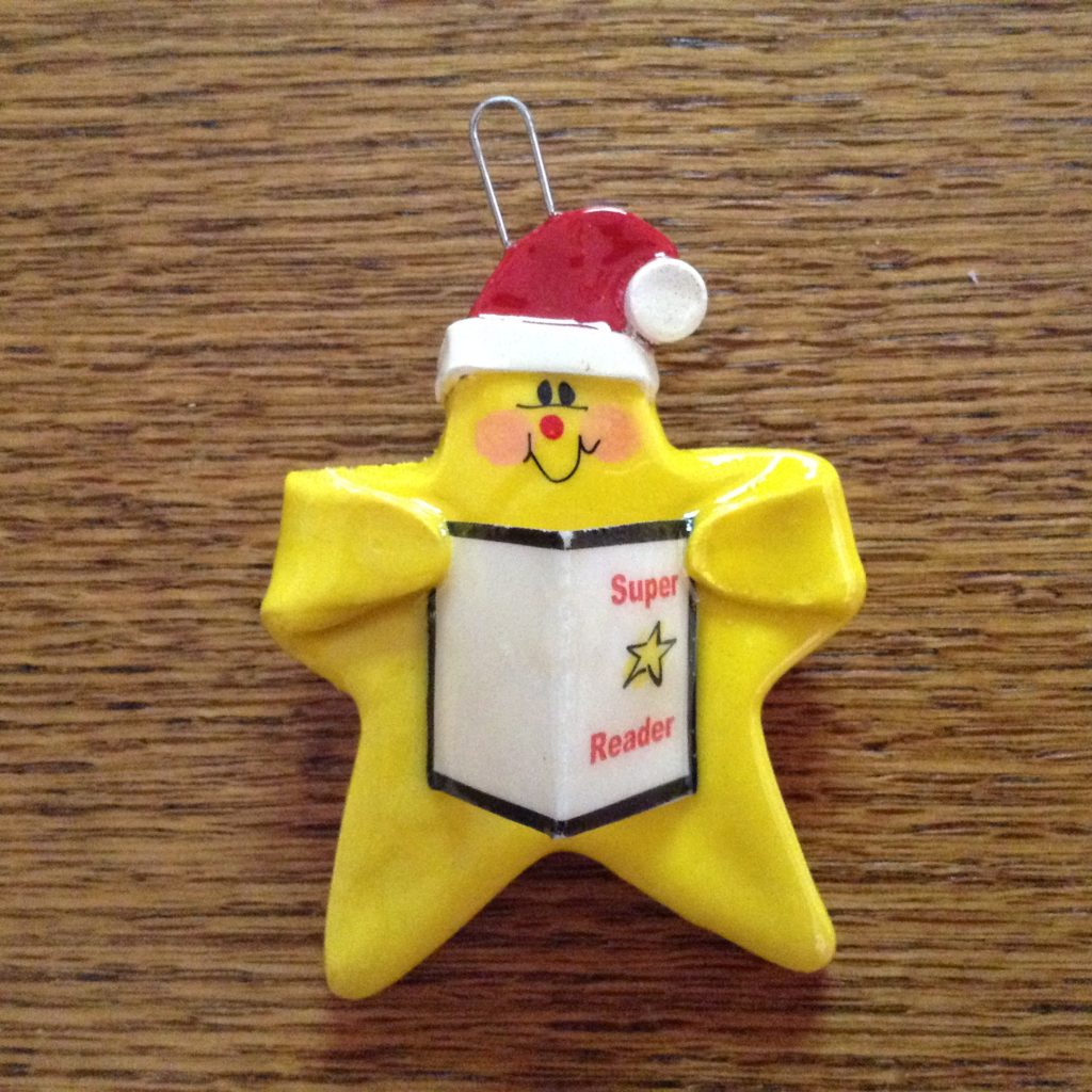 A yellow star with a santa hat on it.