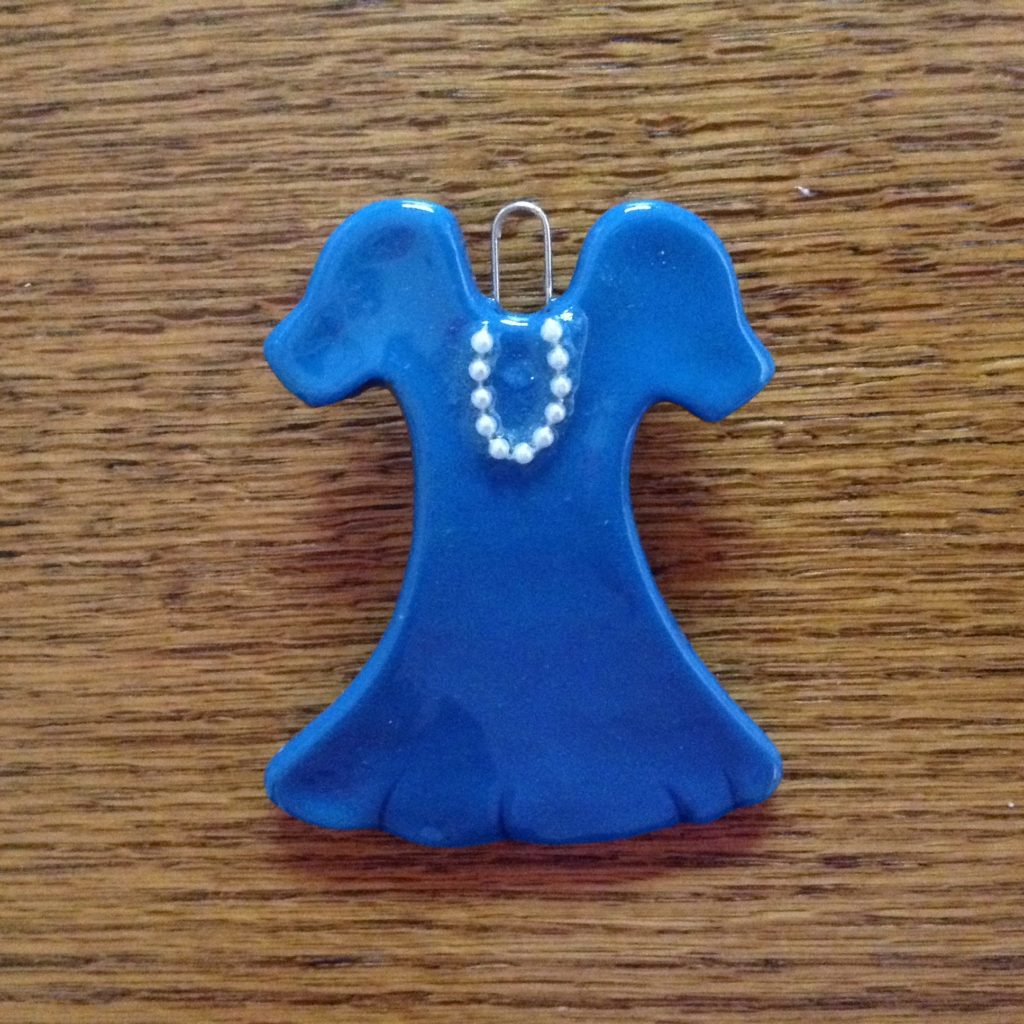A blue dress with a necklace on it