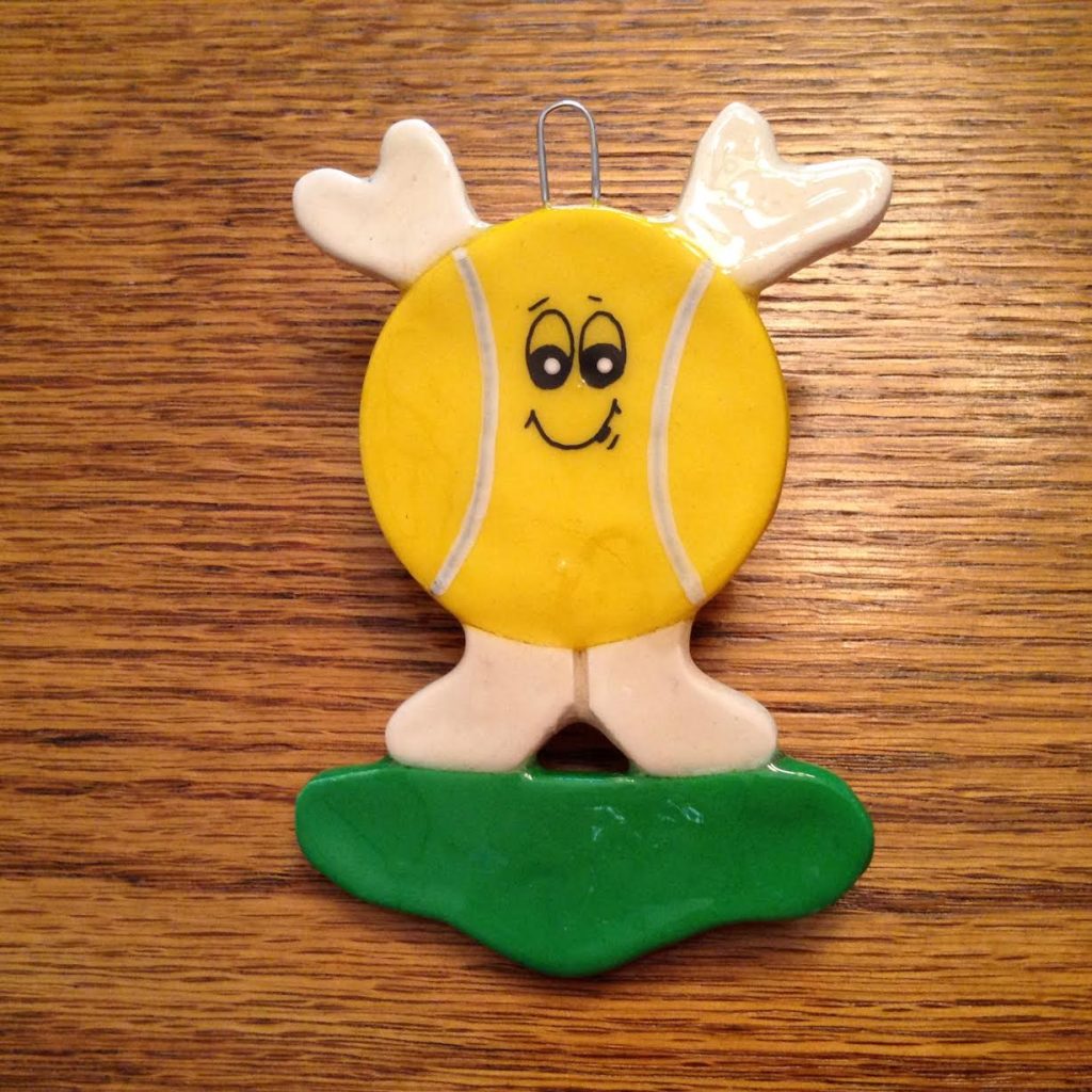 A yellow tennis ball with two hands and feet.