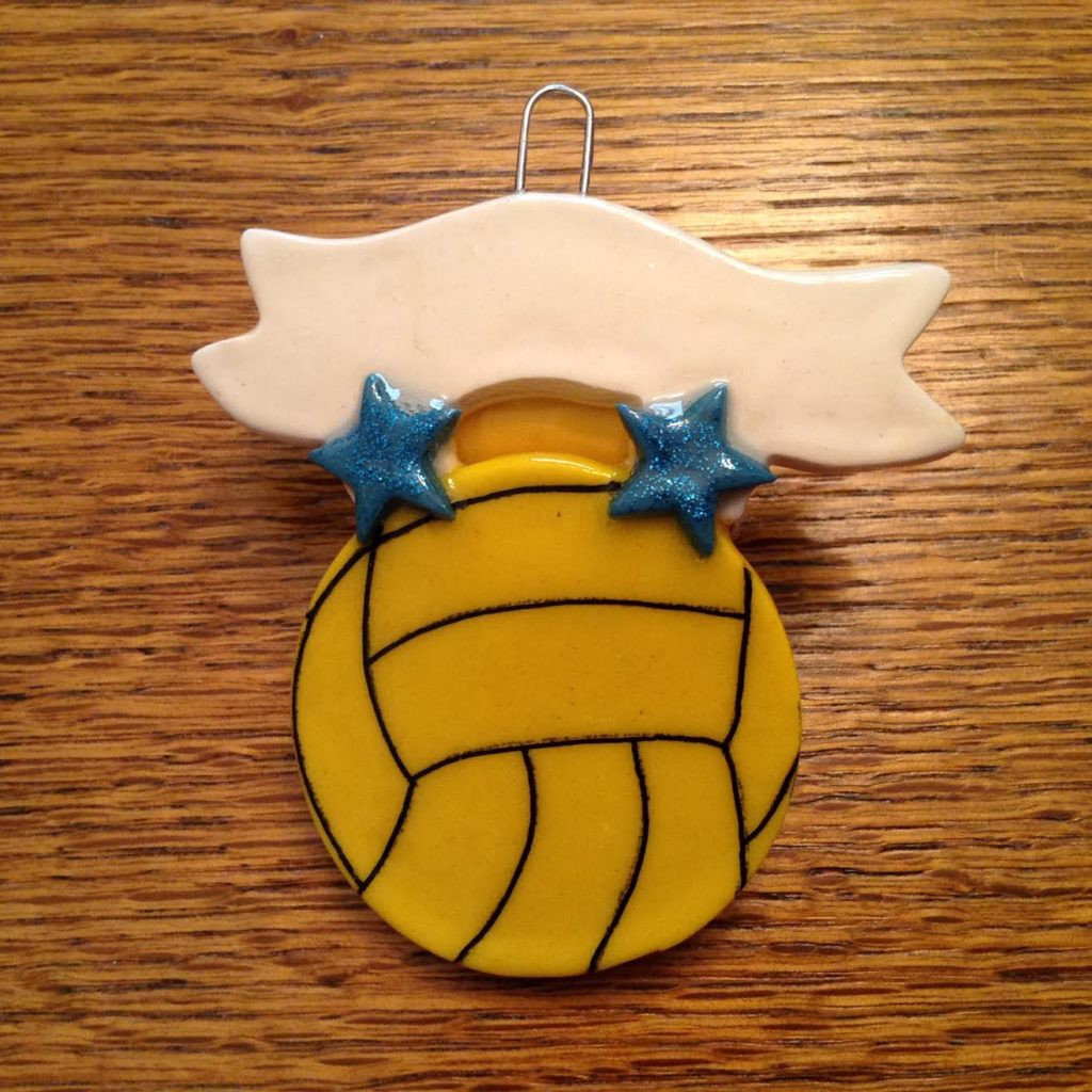 A volleyball ornament with two stars on it.