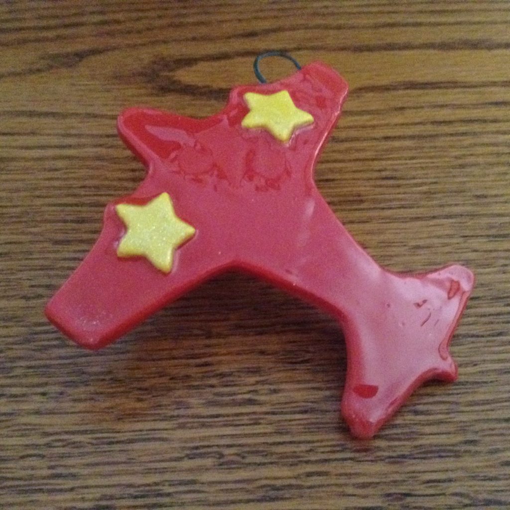 A red star shaped object with yellow stars on it.