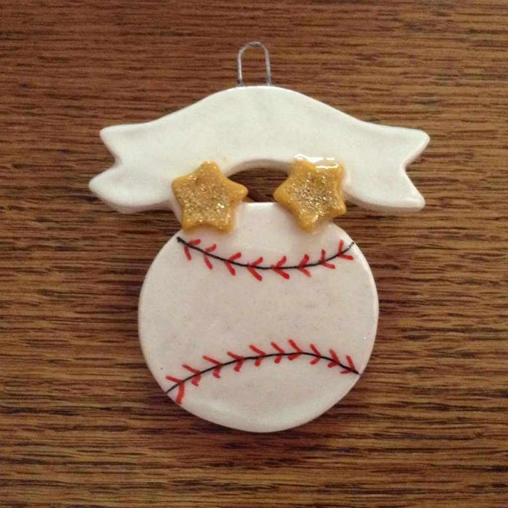 A baseball ornament with two stars on it.