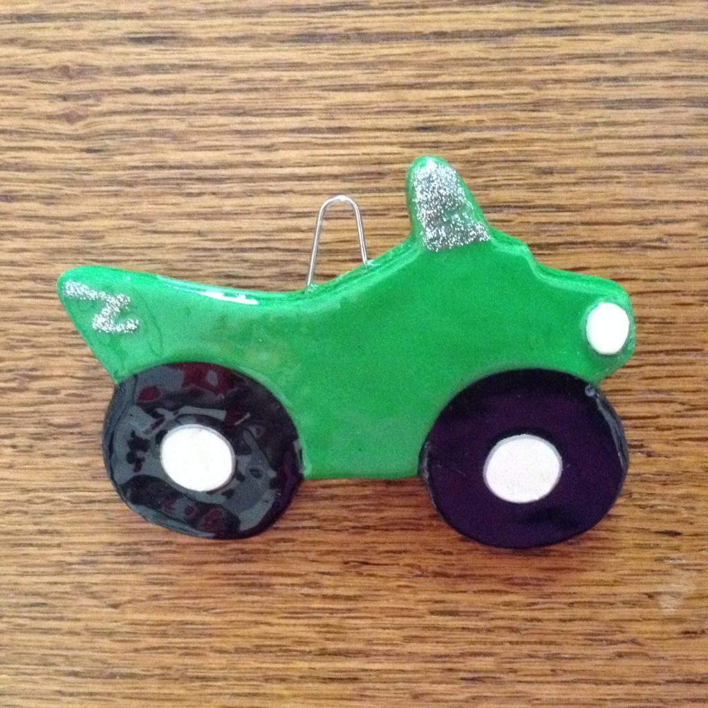 A green toy truck is on the table.