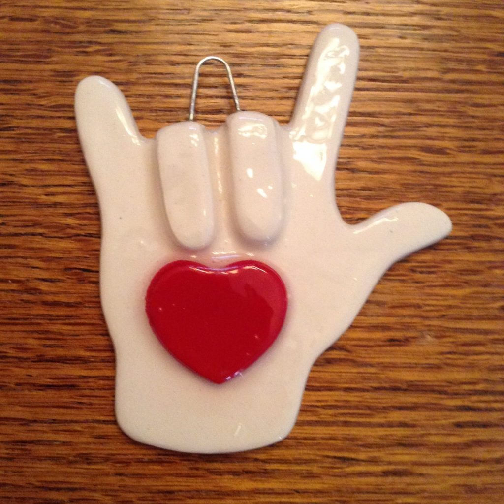 A white hand with a red heart on it.