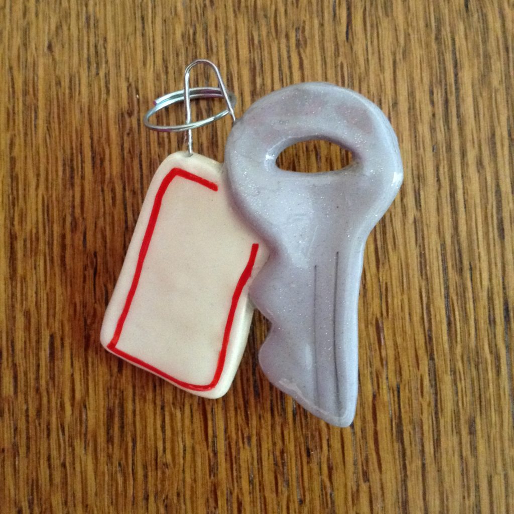 A key with a tag on it and a bottle opener.