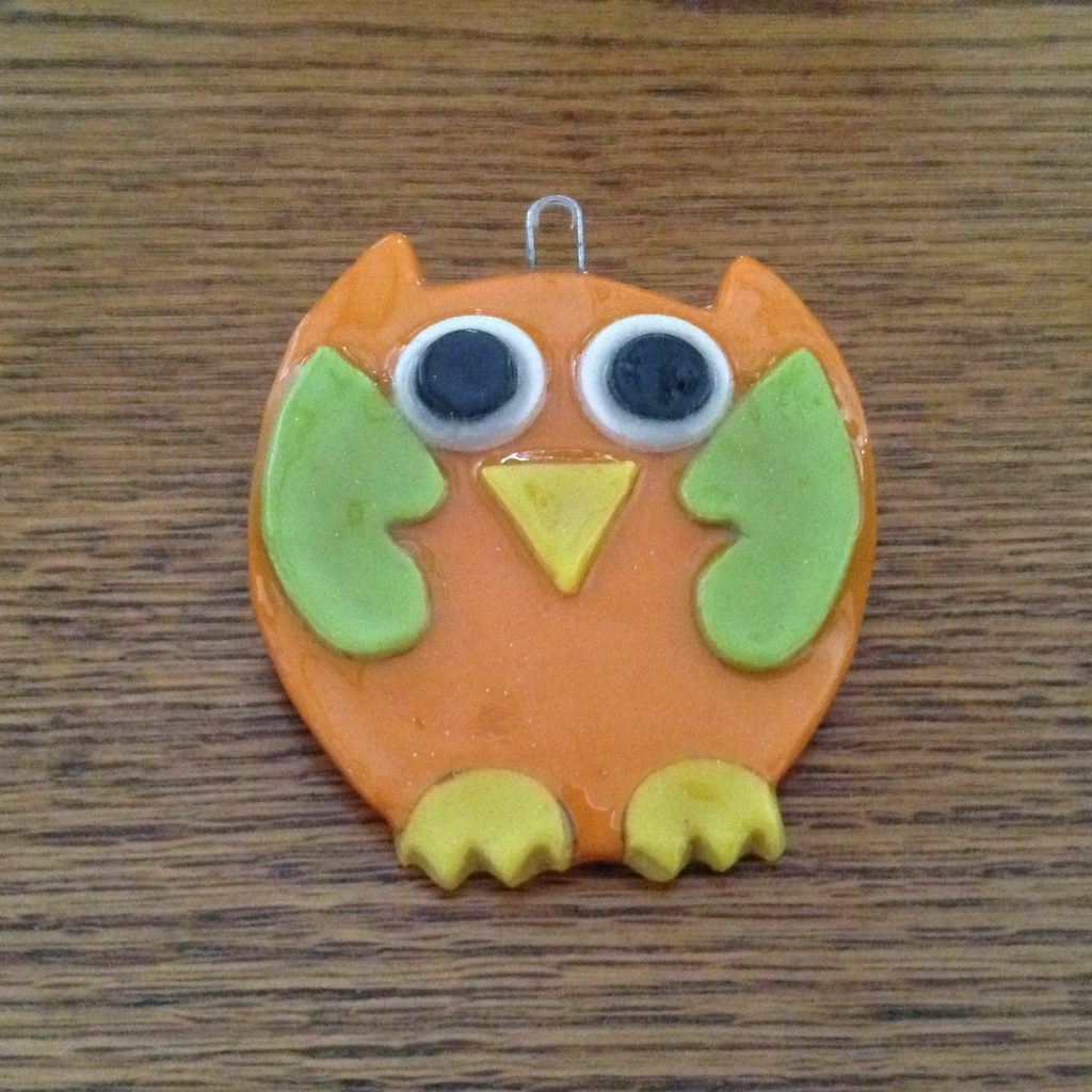 A close up of an owl ornament on a table