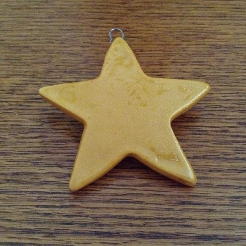A yellow star is sitting on the table.