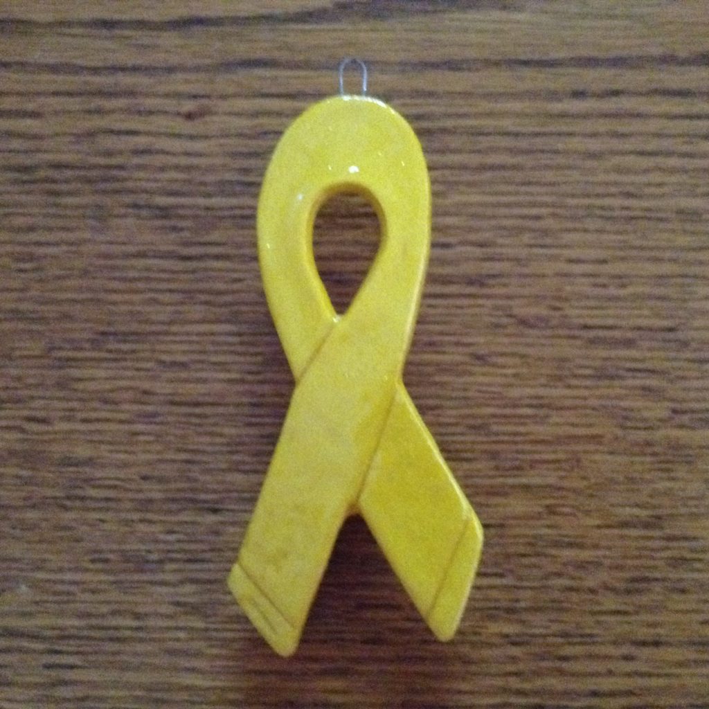 A yellow ribbon is on the table.