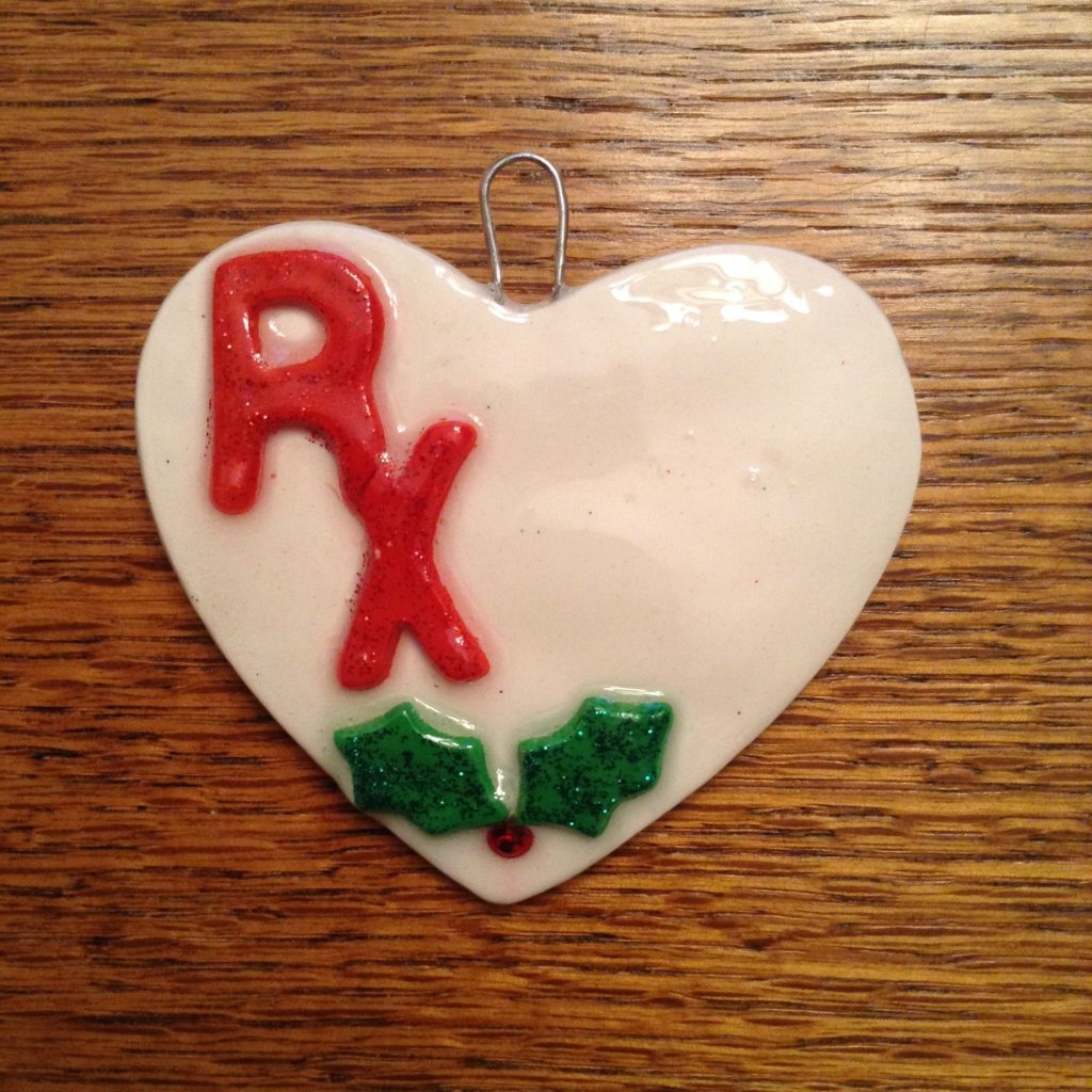 A heart shaped ornament with the word rx written on it.