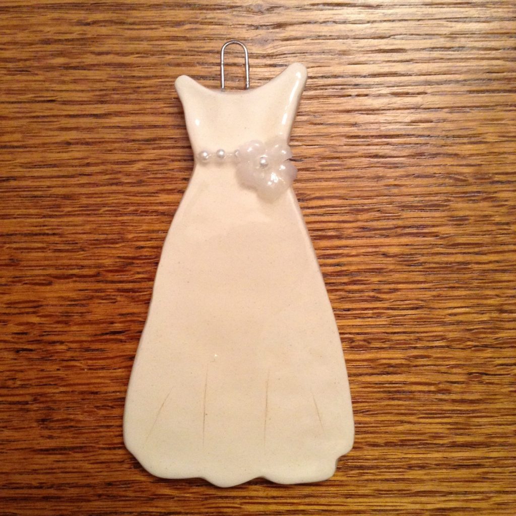 A white dress with a bow on it's waist.