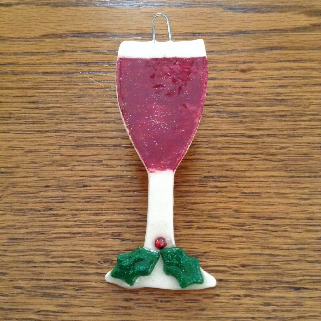 A candle in the shape of a wine glass.