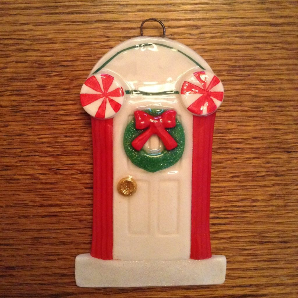 A christmas ornament is hanging on the wall.