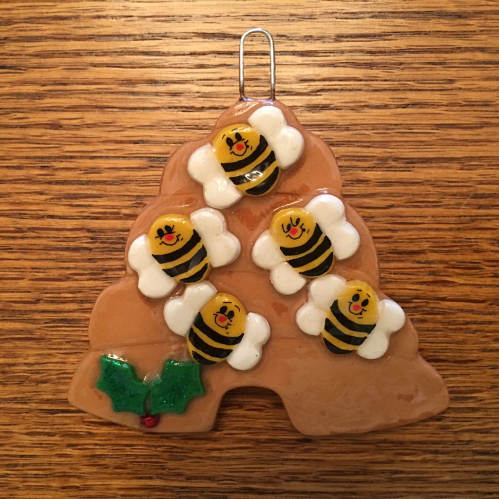 A cookie with bees on it sitting on top of a table.
