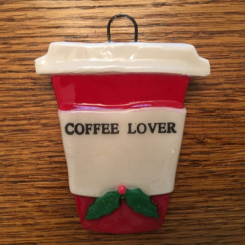 A red and white cup with the words " coffee lover ".