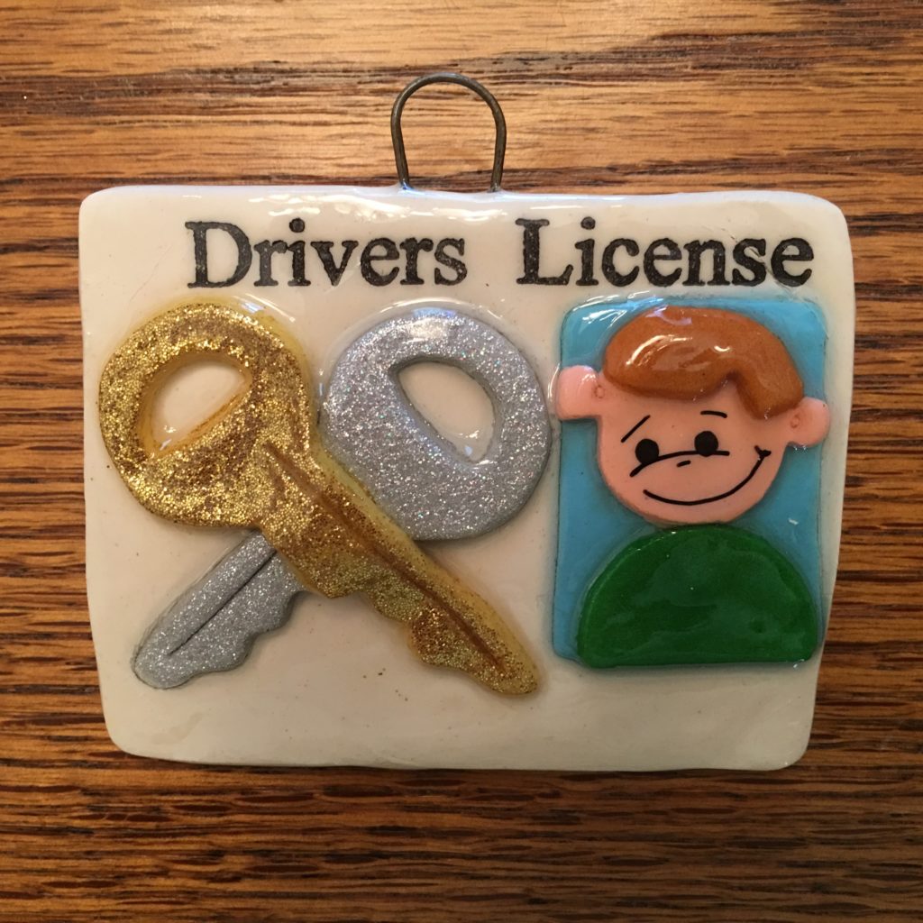 A picture of a drivers license with keys and a man.