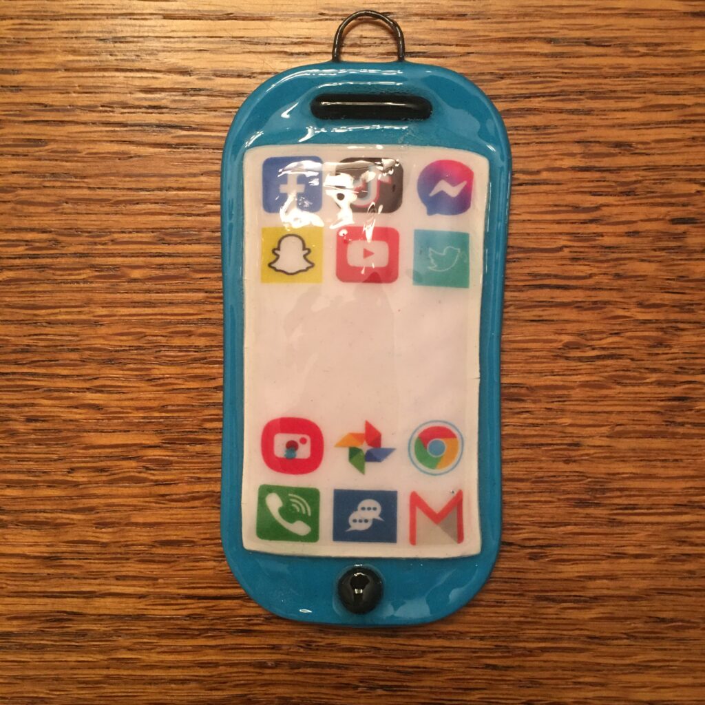 A blue cell phone with many stickers on it.