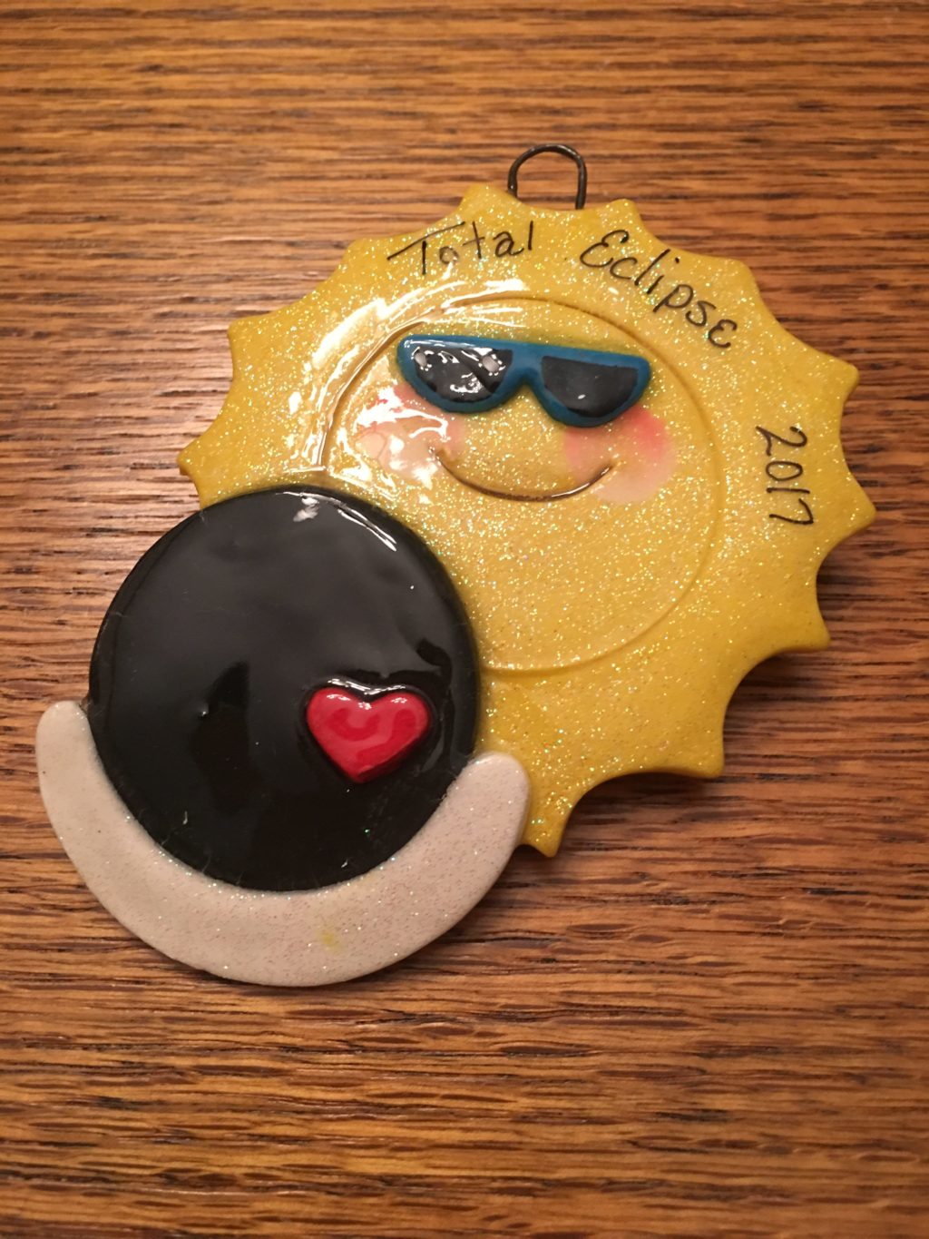 A sun and moon ornament on top of a table.