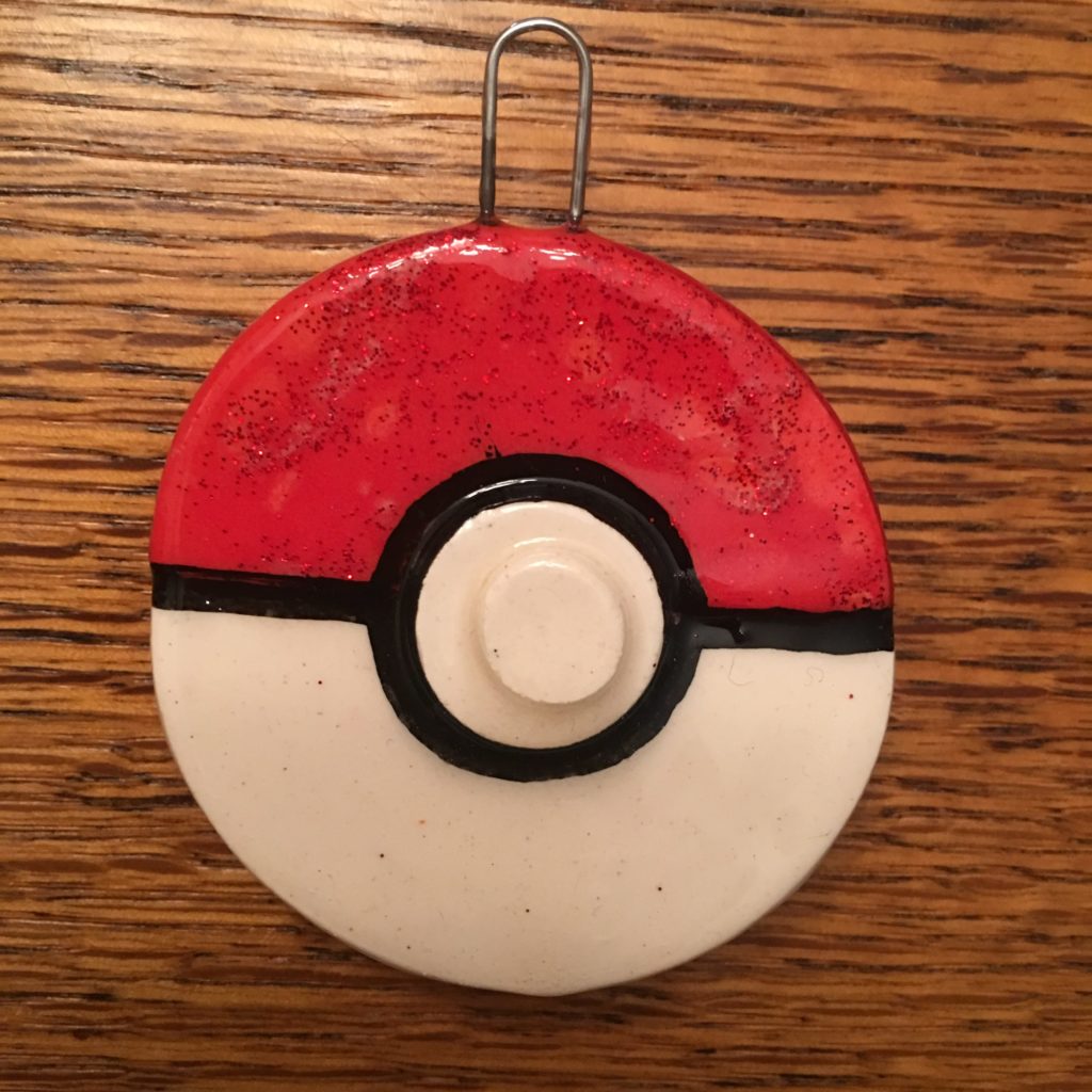 A pokeball ornament is hanging on the wall.