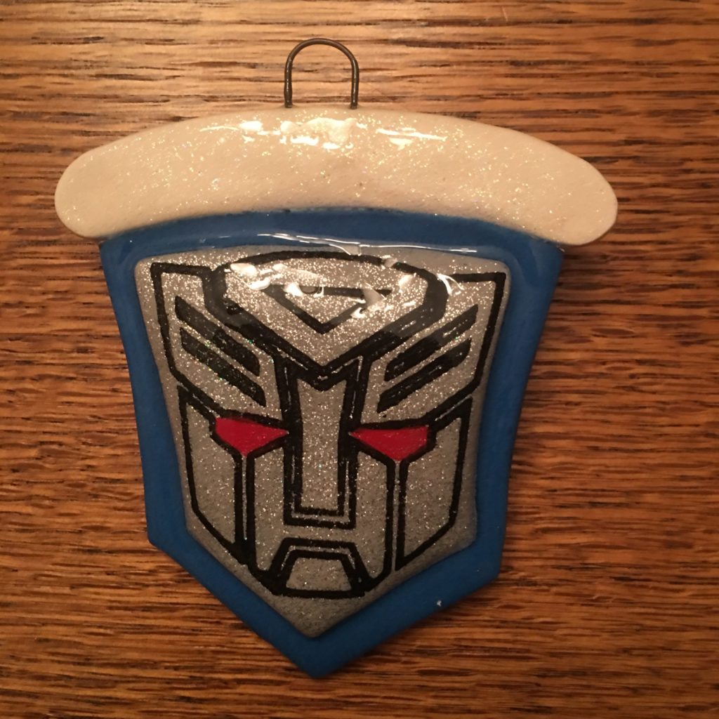 A blue and white ornament with a picture of a robot.