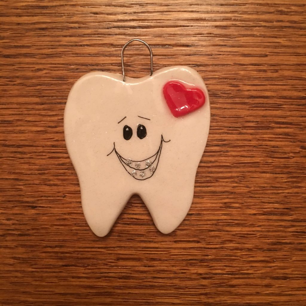 A tooth with a heart on it