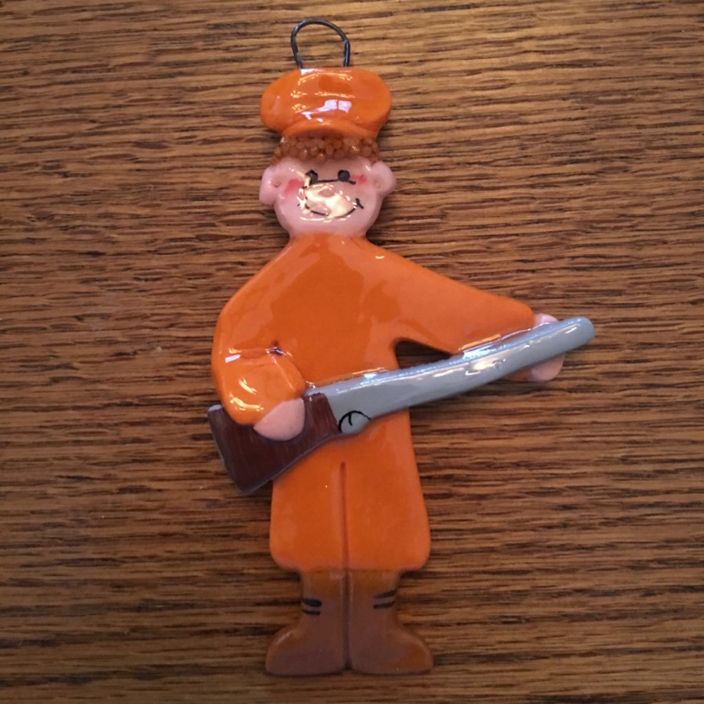 A plastic figure of a man holding a saw.