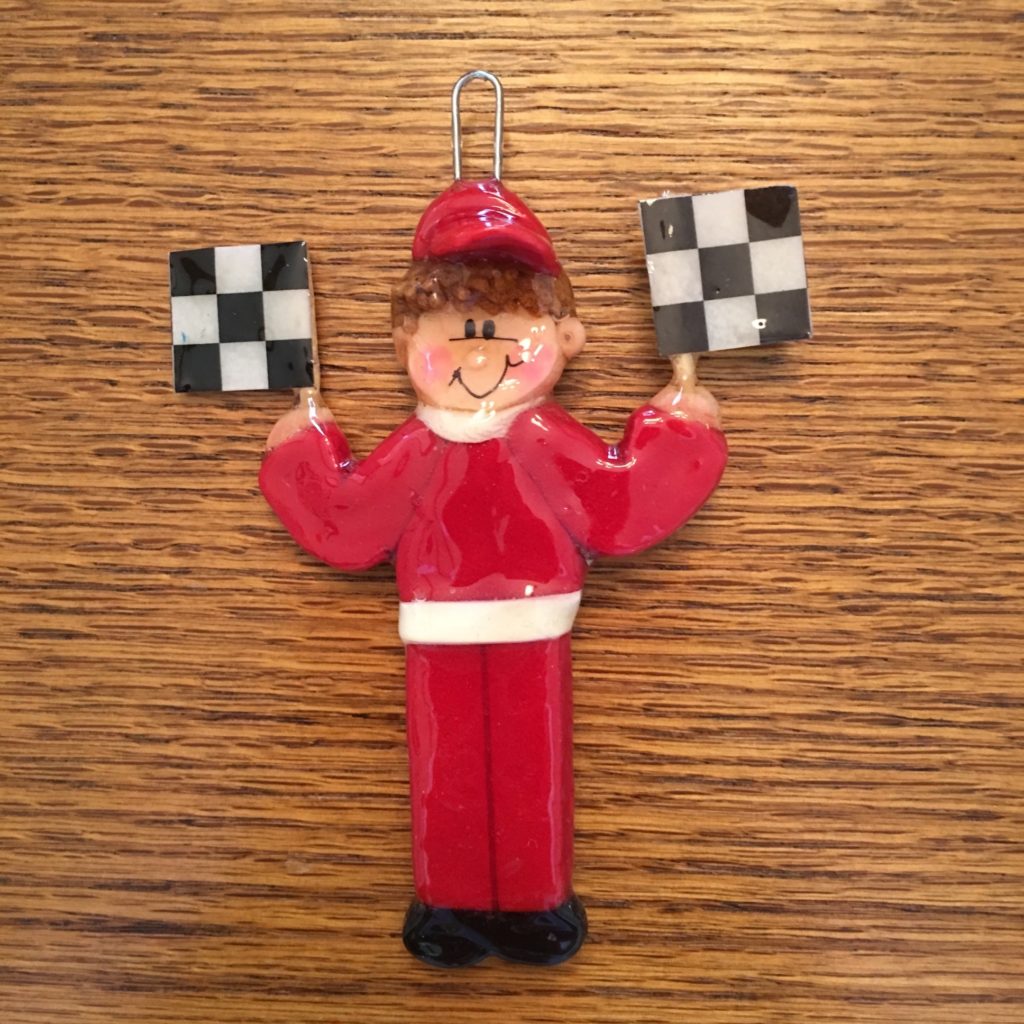 A red and white checkered flag ornament on a wooden table.