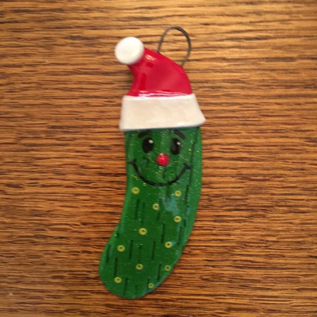 A pickle with a santa hat on it.