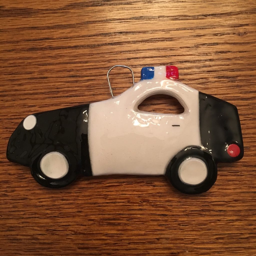 A police car ornament is on the table.
