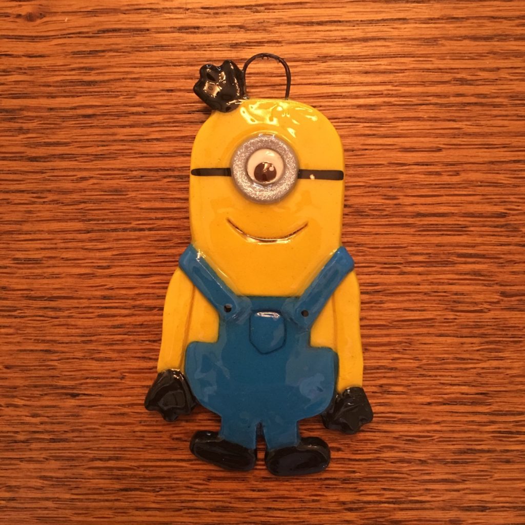 A minion ornament is sitting on top of a table.