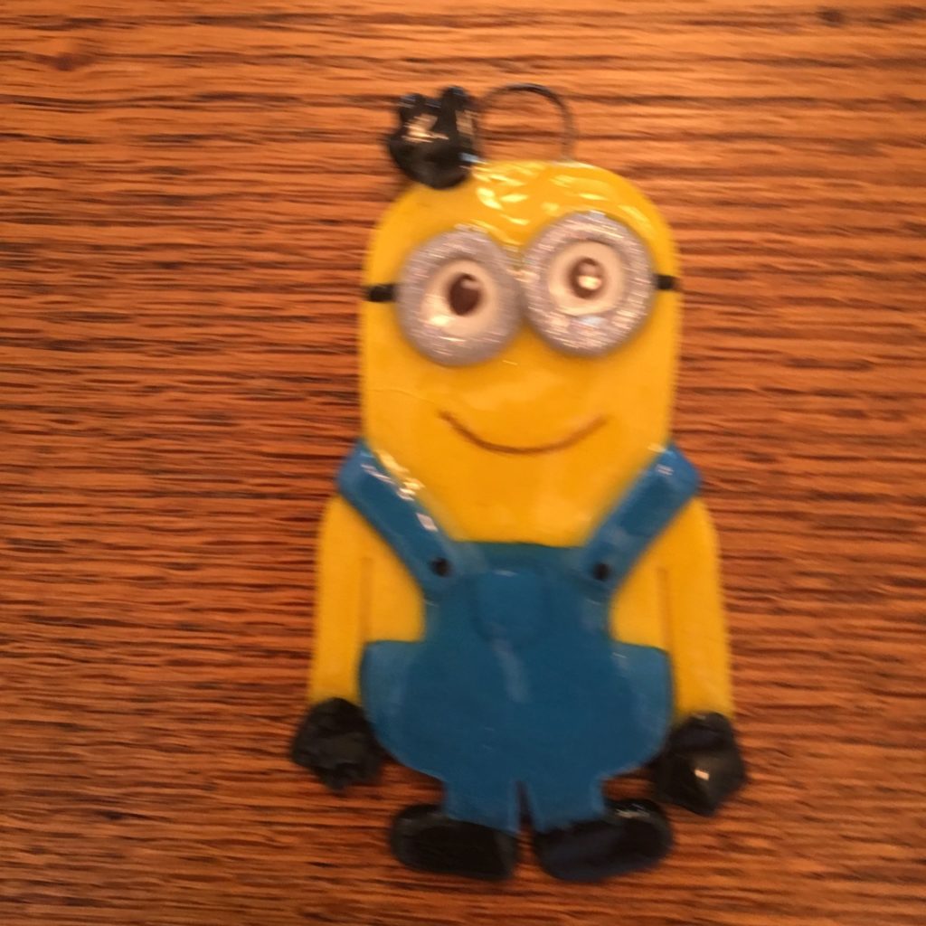 A minion ornament is sitting on the table.