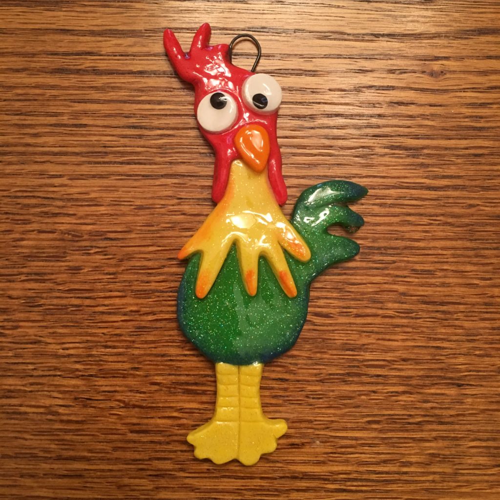 A colorful rooster ornament is hanging on the table.